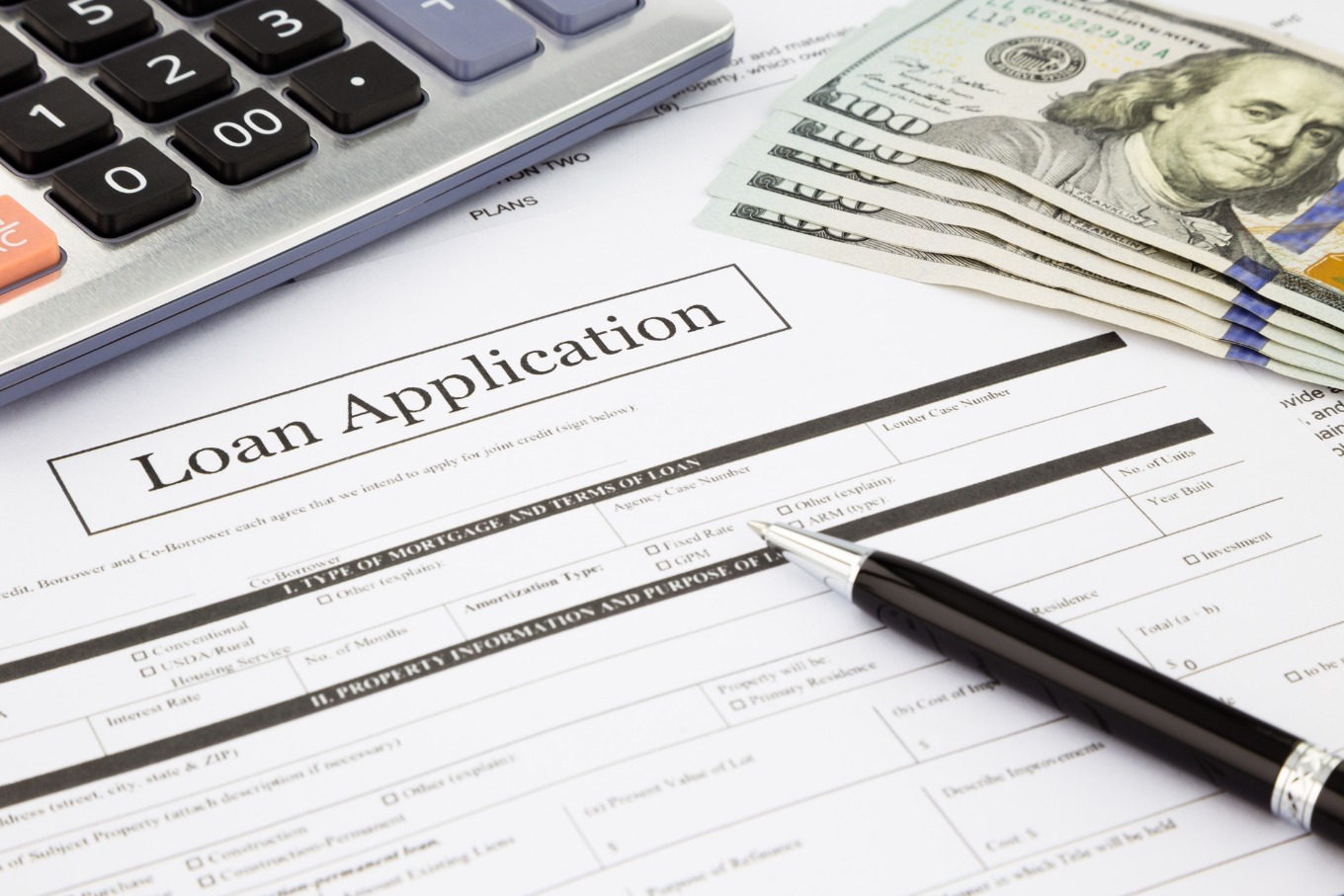 Home loan application with pen and calculator